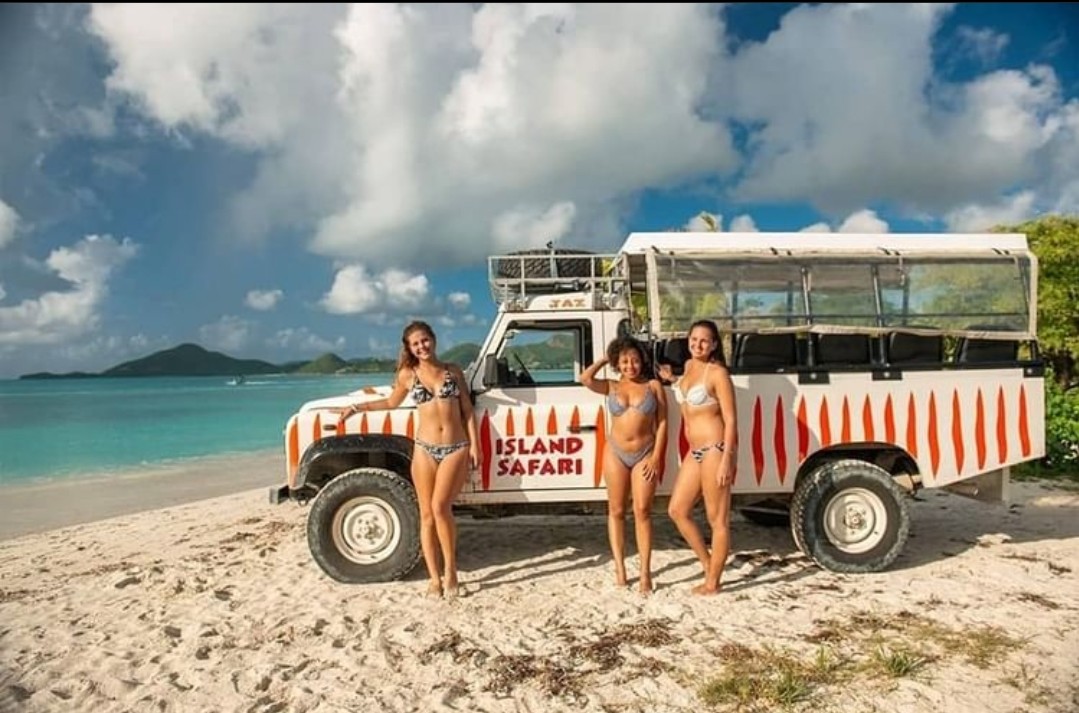 Island Safari jeep tours with guest on the beach
